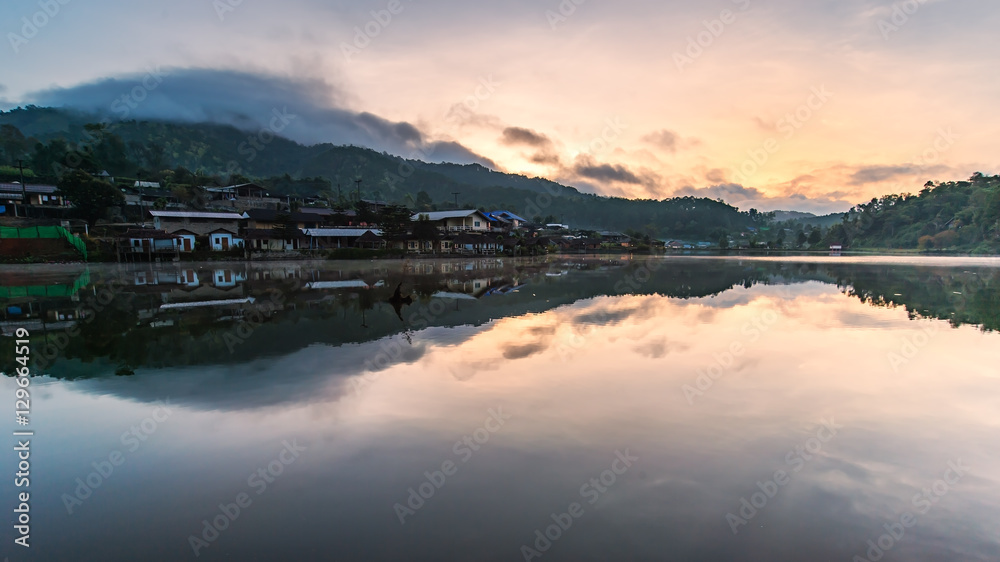 Beautiful view landscape of residence and mountain with blue sky reflected onto the river at Ban Rak Thai, Mae Hong Son, Thailand.