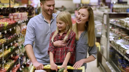 Happy family doing shopping in grocery
 photo