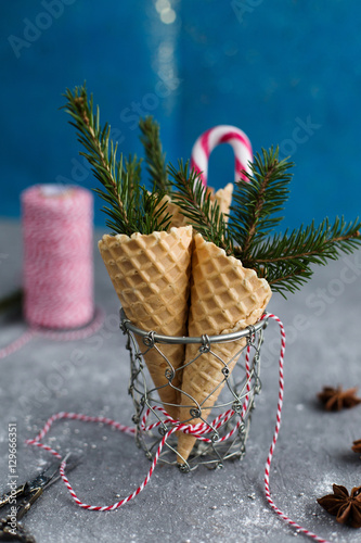 Christmas ice cream cones on blue background (close-up)