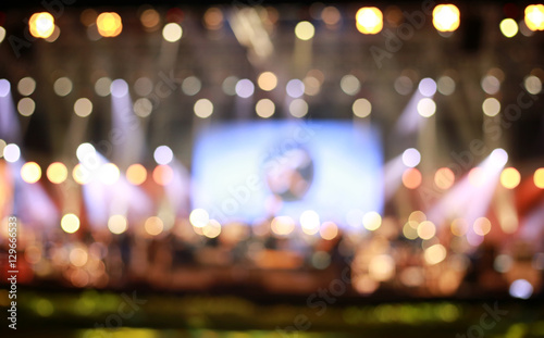 Blurred background : Bokeh lighting in concert with audience ,Music showbiz concept, music performance concert with bokeh spotlight. entertainment concert lighting on stage, blurred disco party. photo