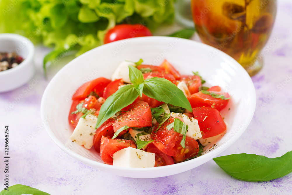 Fresh salad with tomato, mozzarella and basil Fresh salad with tomato, mozzarella and basil