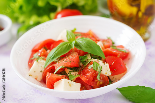 Fresh salad with tomato, mozzarella and basil