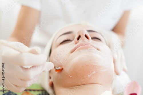 Facial mask.Beautiful young girl relaxing at spa  getting skin treatment
