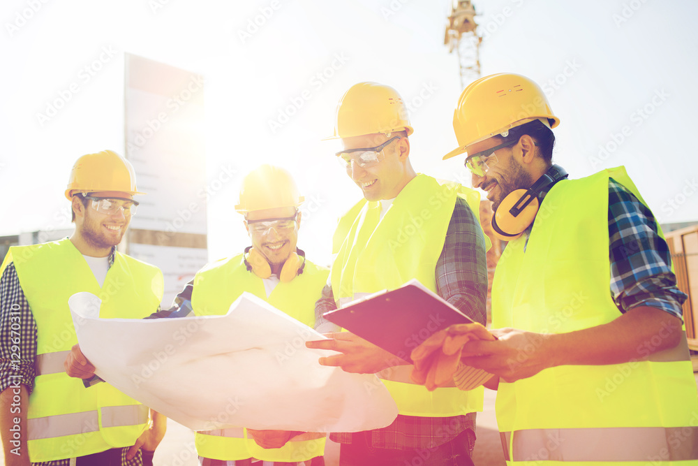group of builders with tablet pc and blueprint