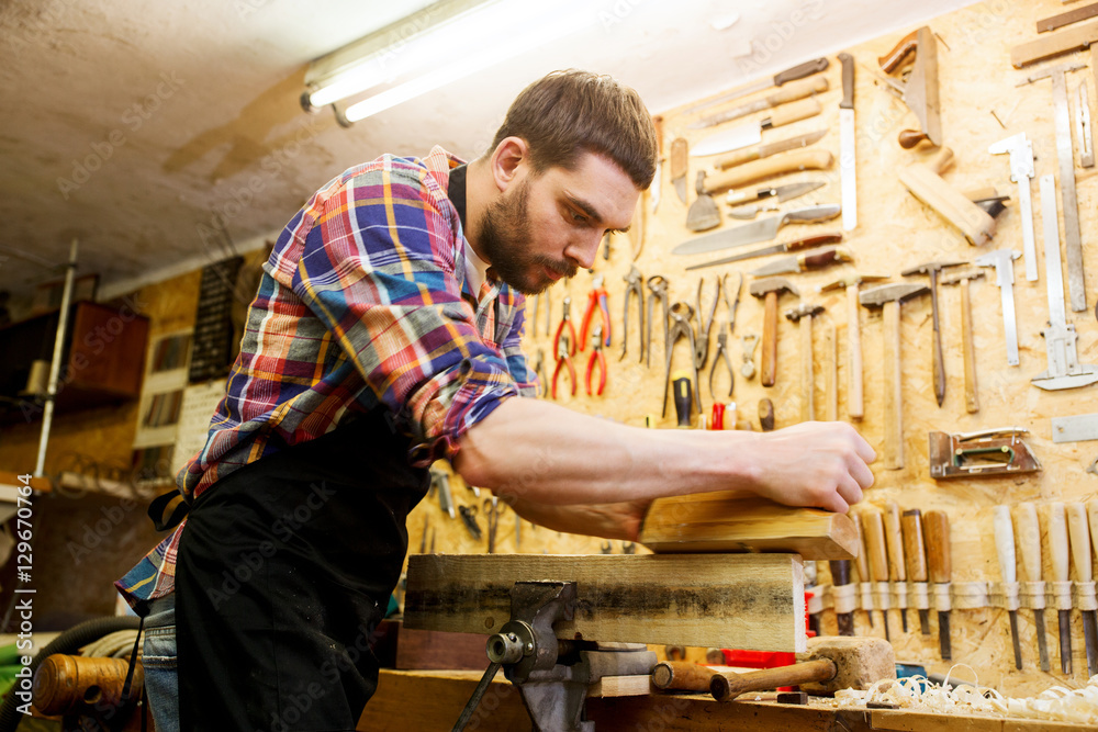carpenter working with plane and wood at workshop carpenter working with plane and wood at workshop