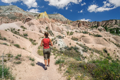 Young girl walking in Red Valley of Cappadocia.