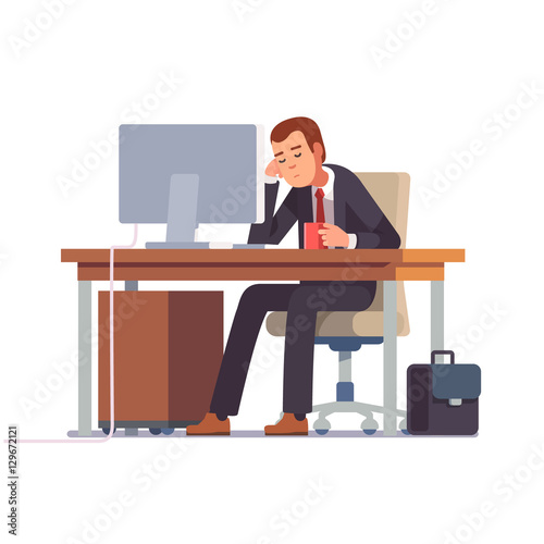 Tired businessman sleeping at his office desk