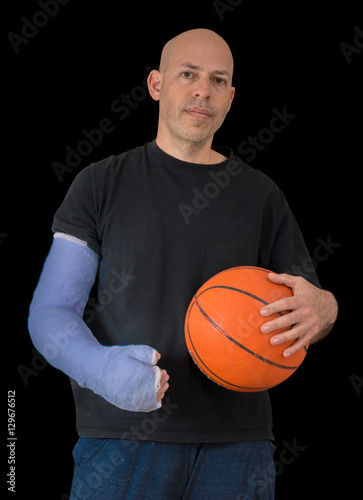 Young man in an arm cast after a basketball accident