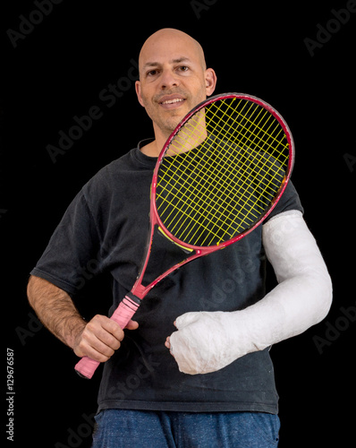 Young man in an arm cast after a tennis accident © Dotan