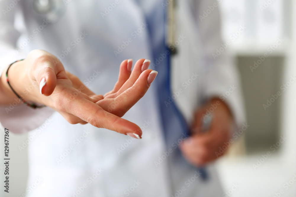 Female medicine doctor offering helping hand closeup