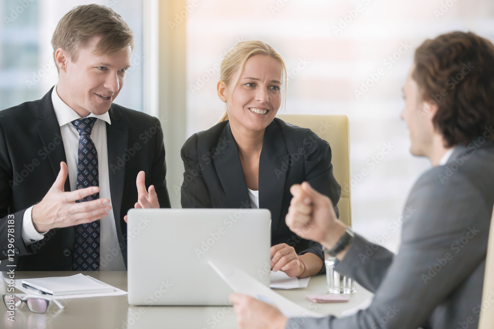 Confident middle aged business man in formal wear explaining his ideas to a client or business partner at meeting, trying to convince, discussing proposal, interviewing vacancy applicant Confident middle aged business man in formal wear explaining his ideas to a client or business partner at meeting, trying to convince, discussing proposal, interviewing vacancy applicant