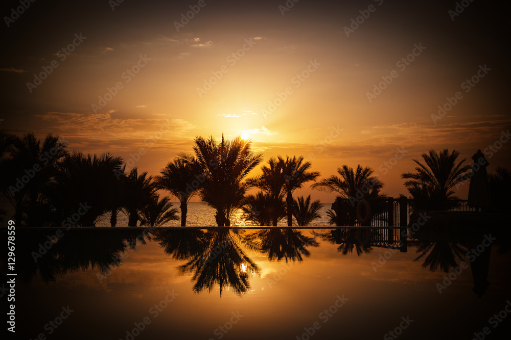 Sunrise over infinity pool and the Red Sea
