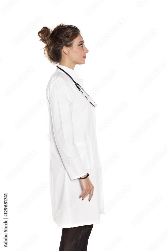 young woman doctor posing on a white background young woman doctor posing on a white background