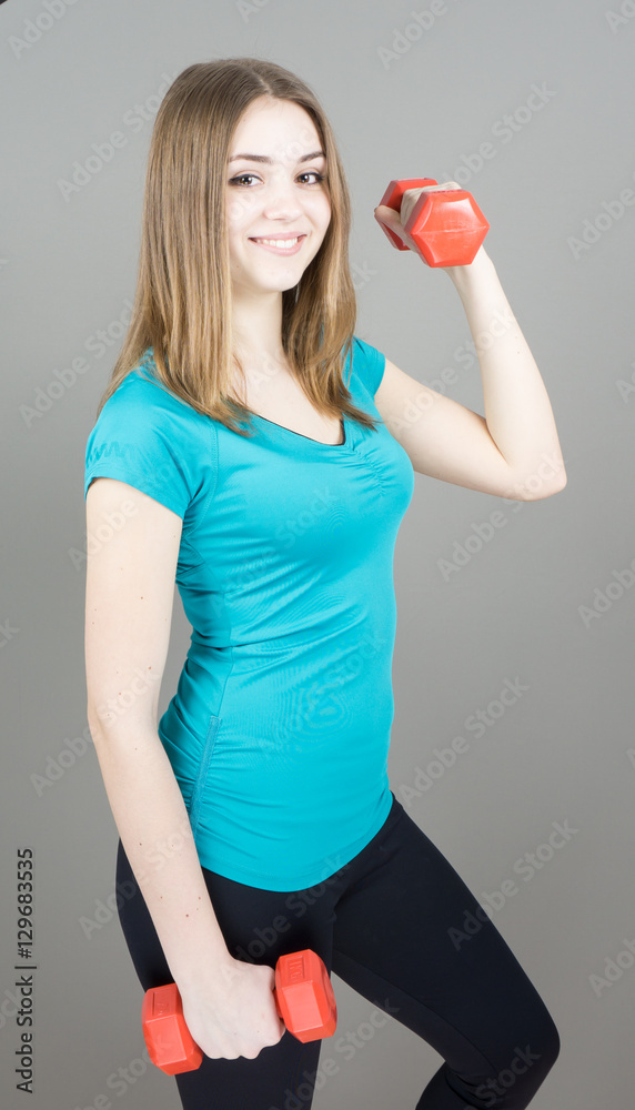 girl with dumpbells on grey background sport concept gym girl with dumpbells on grey background sport concept gym