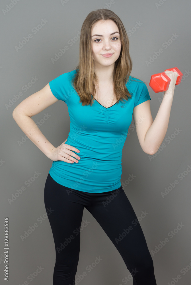 girl with dumpbells on grey background sport concept gym girl with dumpbells on grey background sport concept gym