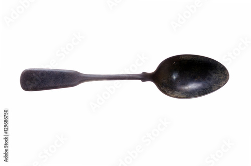 antiquities ancient metal spoon to eat on a white background