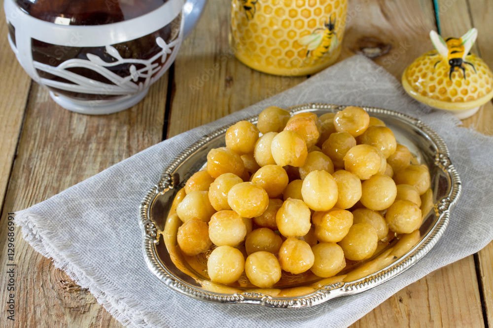 Loukoumades donuts with honey and cinnamon. The concept of celeb Loukoumades donuts with honey and cinnamon. The concept of celeb