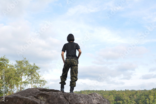 Soldier stand on the rock in nature background 