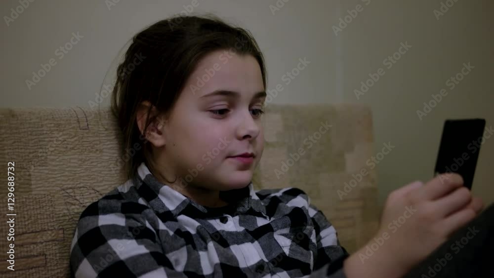Cute Little Teenage Girl Grimaces and Doing Selfie on Mobile Phone Indoor Cute Little Teenage Girl Grimaces and Doing Selfie on Mobile Phone Indoor