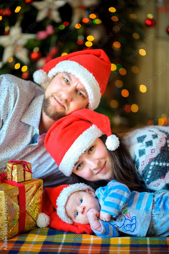 Happy family on a near a fir-tree Happy family on a near a fir-tree