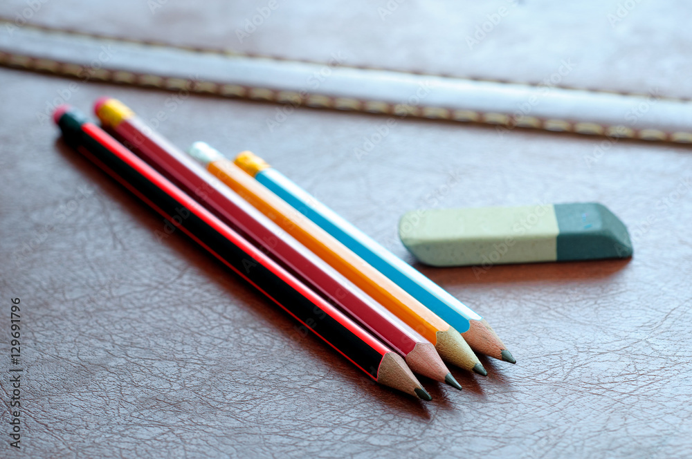Pencils with eraser isolated on leather background. Pencils with eraser isolated on leather background.