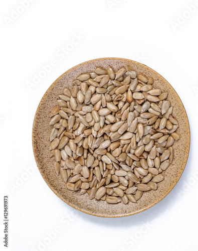 Bio organic sunflower seeds in bowl isolated on white background #129691973