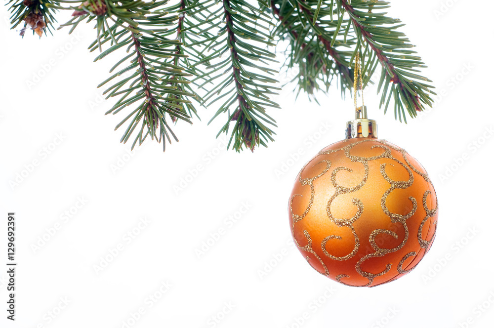 A orange Christmas bauble hanging from a branch of a Christmas 