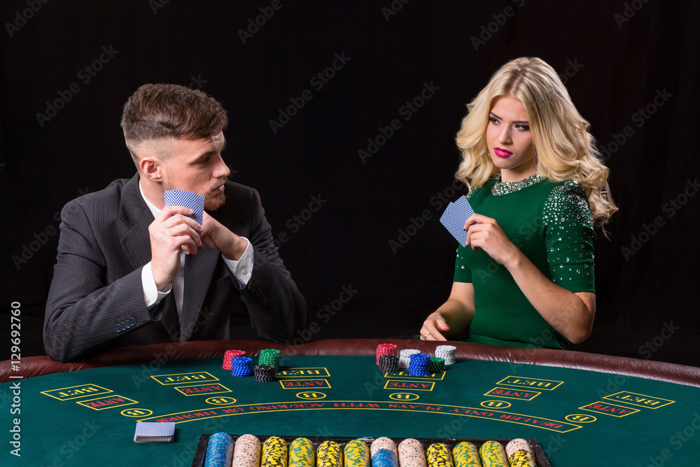 couple playing poker at the table couple playing poker at the table