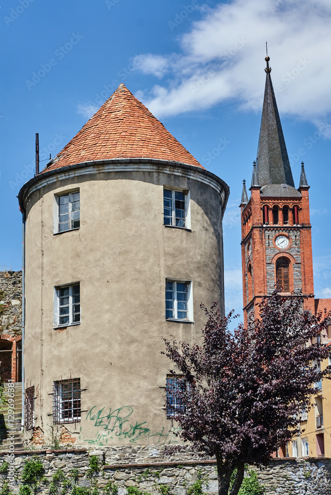 Obraz premium Turret and church tower with a clock in Niemcza.