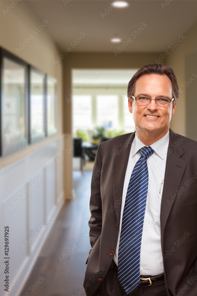 Smiling Businessman In Hallway of New House. Smiling Businessman In Hallway of New House.