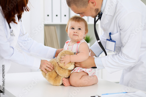 Happy cute baby  at health exam at doctor s office. Medicine and health care concept