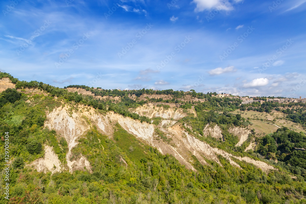 Naklejka premium Civita di Bagnoregio, Italy. View of the mountains and the nearby town of Lubriano