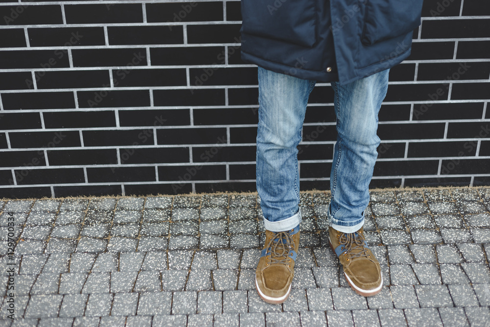 Men fashion, brown leather boots and blue jeans