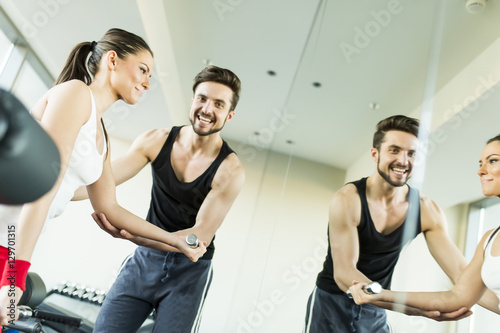 Young woman in gym exercisi...
