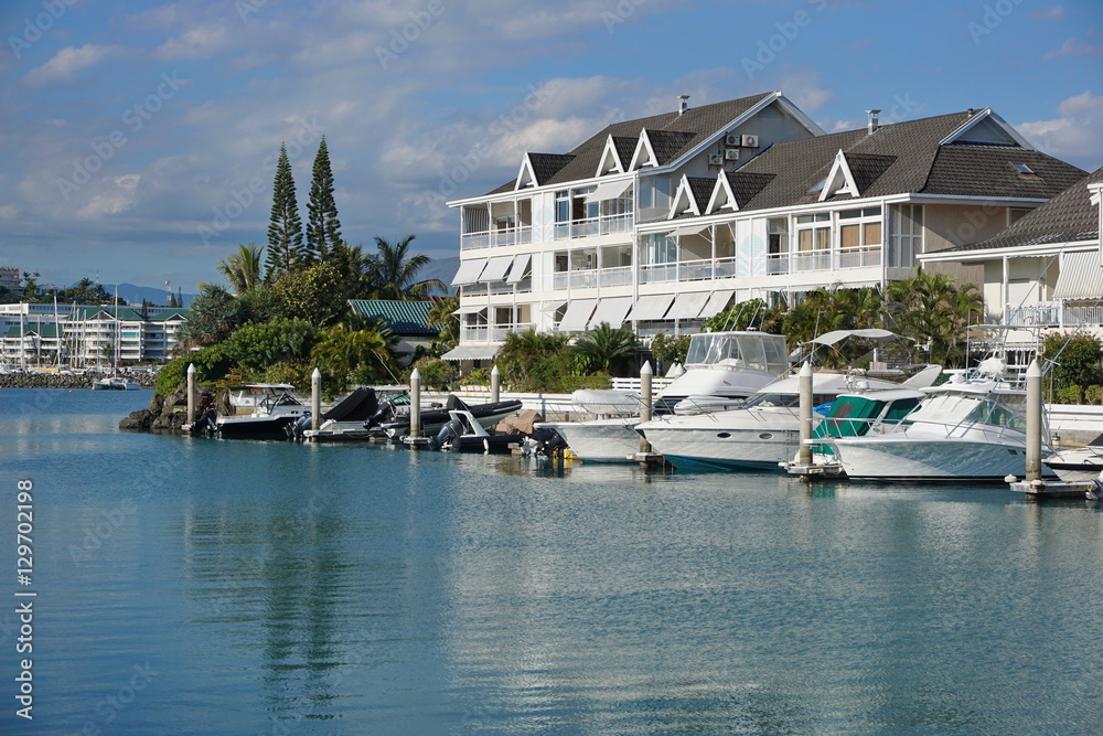 Boats moored in a marina with apartments, Noumea city, Orphelinat bay, Grande Terre island, New Caledonia, south Pacific
