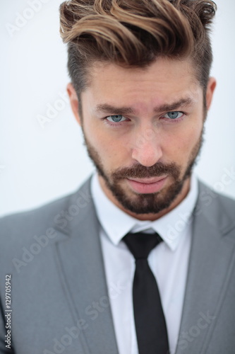 Close up portrait of a smiling handsome business man  over white