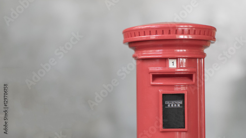 Canvas Print a retro/vintage red post box with a blurred background of a cement wall