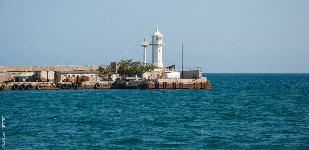 Lighthouse in the Black Sea on the old pier in Yalta