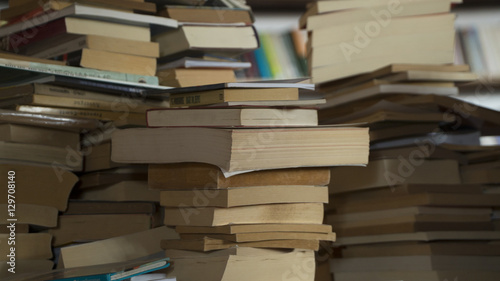 Books at wooden messy library at a school. 