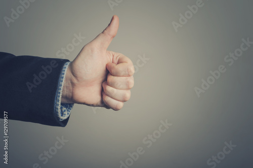 Businessman hand giving thumbs up