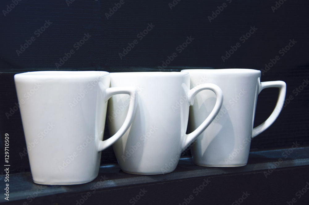 white cups on the black shelf white cups on the black shelf