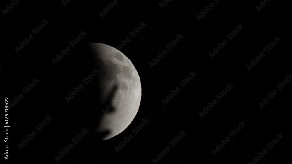 Full moon in partial eclipse slides past branches Full moon in partial eclipse slides past branches