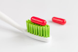 concept toothache with toothbrush and tablet at white background