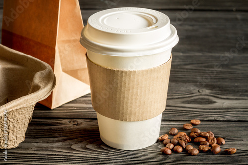 coffee cup to go at wooden background