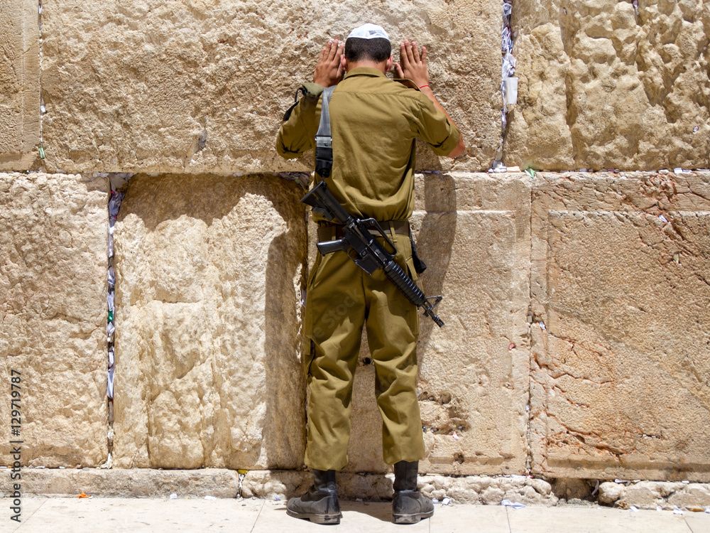 Fototapeta premium Man with tefillin praying at the Wailing Wall, Jerusalem