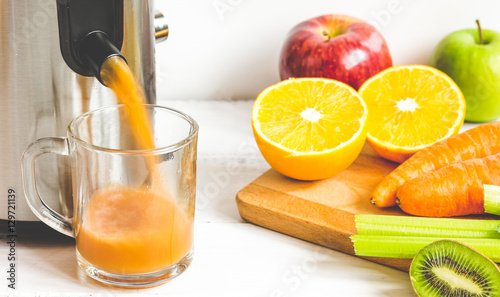 process preparation of fresh juice in juicer photo