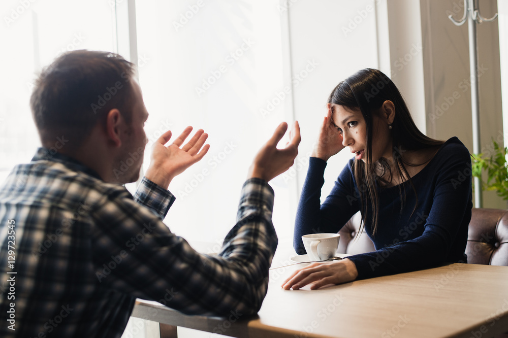 Young couple arguing in a cafe. Relationship problems. Young couple arguing in a cafe. Relationship problems.