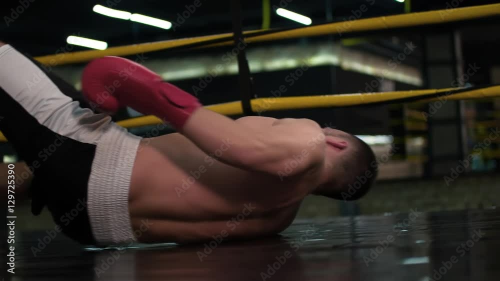 Boxer falling down to boxing ring floor after knockout punch HD slow motion video. Knock out fainting fighter in flight