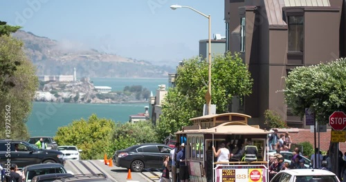 San Francisco Hyde Street Cable Car and Lombard Street. Tourists traveling to the crooked street, fisherman's wharf, and Alcatraz Island.