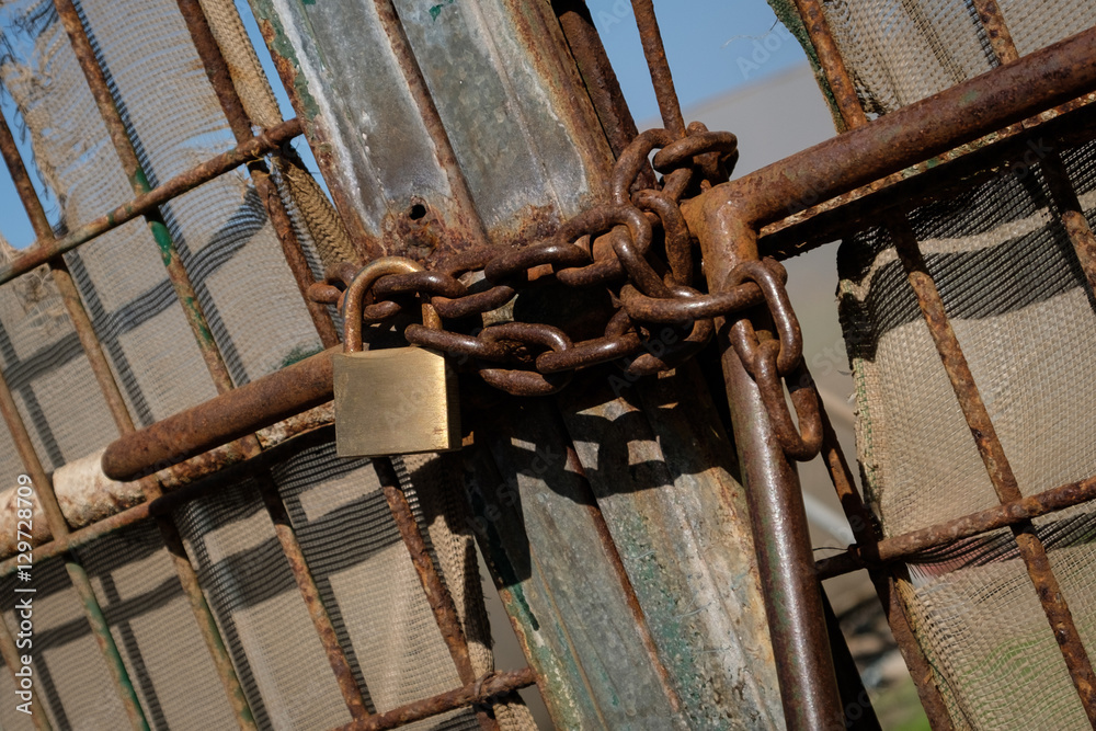 metal gate locked with chain and padlock metal gate locked with chain and padlock
